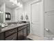 Clean bathroom featuring a vanity with granite countertop, mirror, and white door at 7150 Irongate Dr, Indian Land, SC 29707