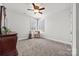 Bedroom with neutral walls, fan and carpet and views of the back yard through shuttered windows at 7150 Irongate Dr, Indian Land, SC 29707