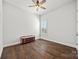Bright bedroom with hardwood floors, window with shutter, and classic accent bench at 7150 Irongate Dr, Indian Land, SC 29707