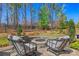 Inviting backyard fire pit featuring stone surround and cozy seating, perfect for outdoor entertaining at 7150 Irongate Dr, Indian Land, SC 29707