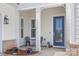Charming front porch adorned with bistro set and vibrant flowers at 7150 Irongate Dr, Indian Land, SC 29707