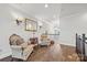 Upstairs hallway featuring hardwood floors, decorative wall sconces, and comfortable seating at 7150 Irongate Dr, Indian Land, SC 29707