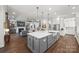 Open-concept kitchen with island and view to the living room at 7150 Irongate Dr, Indian Land, SC 29707