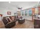 Cozy living room featuring hardwood floors, comfortable seating, and natural light from the windows at 7150 Irongate Dr, Indian Land, SC 29707