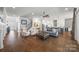 Spacious living room with hardwood floors, fireplace, and open layout to kitchen at 7150 Irongate Dr, Indian Land, SC 29707