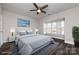 Virtually staged bedroom with bay window and ceiling fan at 768 Marsh Rd # 3, Charlotte, NC 28209