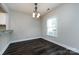 Simple dining room with dark floors and large window at 768 Marsh Rd # 3, Charlotte, NC 28209