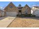 Two-story house with stone facade, two-car garage, and landscaping at 9314 Dufaux Dr, Charlotte, NC 28278