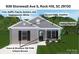 House exterior with gray siding, white trim, and bronze doors and shutters at 939 Stonewall S Ave, Rock Hill, SC 29730