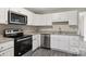 Well-equipped kitchen with white cabinets, granite countertops, and stainless steel appliances at 939 Stonewall S Ave, Rock Hill, SC 29730