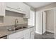 Kitchen with double sink, granite countertops, and white cabinets at 939 Stonewall S Ave, Rock Hill, SC 29730
