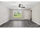 Bright living room featuring gray vinyl plank flooring and a ceiling fan at 939 Stonewall S Ave, Rock Hill, SC 29730