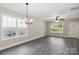 Bright living room with grey vinyl plank flooring, ceiling fan, and chandelier at 939 Stonewall S Ave, Rock Hill, SC 29730