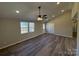 Spacious living room featuring vaulted ceilings, hardwood floors, and a ceiling fan at 110 Gilliatt St, Shelby, NC 28150