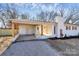 Covered carport with attached storage and steps at 1115 218 W Hwy, Indian Trail, NC 28079