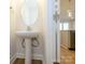 Modern powder room featuring a stylish pedestal sink with stainless steel faucet and an oval mirror at 113 Quartz Hill Way, Waxhaw, NC 28173