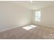 Bright bedroom with carpet flooring and a large window offering natural light at 113 Quartz Hill Way, Waxhaw, NC 28173