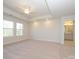 Large bedroom with tray ceiling, carpet, large windows for natural light, and ensuite bathroom access at 113 Quartz Hill Way, Waxhaw, NC 28173