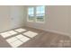 Bright bedroom with carpet flooring and two windows offering natural light at 113 Quartz Hill Way, Waxhaw, NC 28173