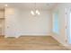 Bright dining room featuring wood flooring, a modern light fixture, and a large window at 113 Quartz Hill Way, Waxhaw, NC 28173