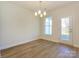 A dining room with light hardwood flooring, a stylish chandelier, and a door leading to the outside at 113 Quartz Hill Way, Waxhaw, NC 28173