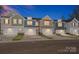 Charming new townhomes feature attached garages and stone accents for modern curb appeal in a walkable neighborhood at 113 Quartz Hill Way, Waxhaw, NC 28173