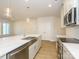 Bright kitchen features a large island with a stainless steel sink and appliances, and pendant lighting at 113 Quartz Hill Way, Waxhaw, NC 28173