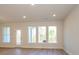 Bright living room with hardwood floors, large windows overlooking the backyard, and access to the patio at 113 Quartz Hill Way, Waxhaw, NC 28173