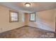 Bright bedroom with neutral carpeting and two windows at 1135 12Th Ne St, Hickory, NC 28601