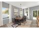 Dining area with gray walls, wood table, and access to the backyard at 11408 Magpie Ct # 12, Charlotte, NC 28215