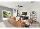 Spacious living area with a comfy leather couch and sliding glass doors at 11408 Magpie Ct # 12, Charlotte, NC 28215