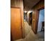 Long hallway with wood paneling and access to other rooms at 1196 Old Thompson Ave, Lancaster, SC 29720