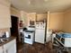 Galley kitchen with white appliances and ample cabinet space at 1196 Old Thompson Ave, Lancaster, SC 29720