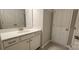 Bathroom with single vanity, white cabinets, and brushed gold fixtures at 135 Ella Claire Dr, York, SC 29745
