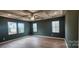 Spacious bedroom with tray ceiling, neutral walls, and hardwood flooring at 135 Ella Claire Dr, York, SC 29745
