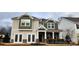 Two-story house with green and beige siding, stone accents, and a double door entry at 135 Ella Claire Dr, York, SC 29745