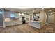 Open kitchen with white cabinets, quartz island, stainless steel appliances, and subway tile backsplash at 135 Ella Claire Dr, York, SC 29745