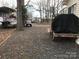Gravel yard with boat, ATV, and grill at 135/137 Indian Harbor Trl # E16/17, Mount Gilead, NC 27306