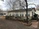Cream-colored house with large windows, deck, and surrounding trees at 135/137 Indian Harbor Trl # E16/17, Mount Gilead, NC 27306