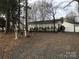 Exterior of a single story home with a gravel driveway at 135/137 Indian Harbor Trl # E16/17, Mount Gilead, NC 27306