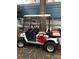 Side view of red and white EZGO golf cart at 135/137 Indian Harbor Trl # E16/17, Mount Gilead, NC 27306