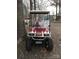 Red and white EZGO golf cart with large tires at 135/137 Indian Harbor Trl # E16/17, Mount Gilead, NC 27306