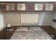 Main bedroom with a floral comforter and nightstand at 135/137 Indian Harbor Trl # E16/17, Mount Gilead, NC 27306