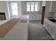Bright kitchen featuring a spacious island, white cabinetry, and abundant natural light at 13605 Tranquil Day Dr, Matthews, NC 28105