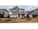 Two-story home with gray and white siding, brick accents, and a landscaped lawn at 139 Ella Claire Dr, York, SC 29745