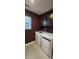 Laundry room with dark cabinets, washer, and dryer, burgundy walls at 139 Ella Claire Dr, York, SC 29745