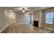 Living room with fireplace, wood-look floors, and vertical shiplap feature wall at 139 Ella Claire Dr, York, SC 29745
