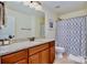 Bathroom with single vanity and a gray shower curtain at 14015 Helen Benson Blvd, Davidson, NC 28036
