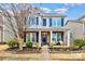 Two-story home with brick and siding, welcoming porch, and landscaped yard at 14015 Helen Benson Blvd, Davidson, NC 28036