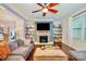 Spacious living room features a stone fireplace and built-in shelving at 14015 Helen Benson Blvd, Davidson, NC 28036